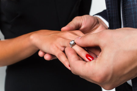 The perfect moment. Close-up of loving men putting ring to his girlfriend
