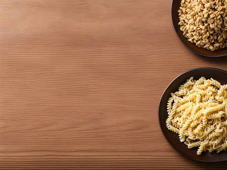 Whole wheat pasta in brown bowl on wooden background. top viewの素材