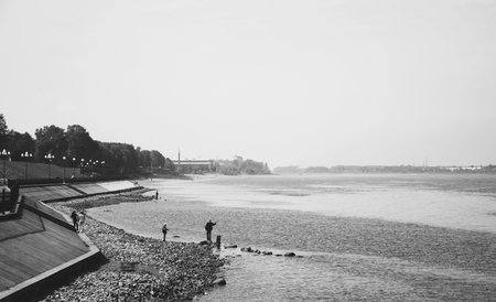 Man standing on the river bank. Volga river. Black and white.