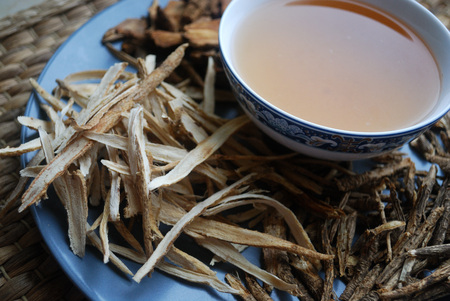 Bowl of chinese herb tea with dried assorted roots.の写真素材