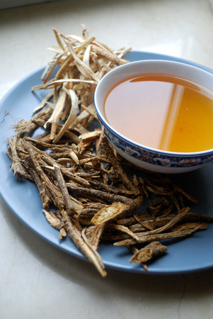Bowl of chinese herb tea with dried assorted roots.の写真素材