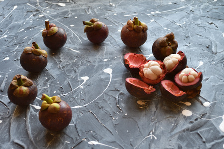 Fresh mangosteen fruits isolated on neutral background.の写真素材