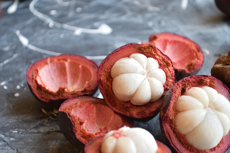 Fresh mangosteen fruits isolated on neutral background.の写真素材