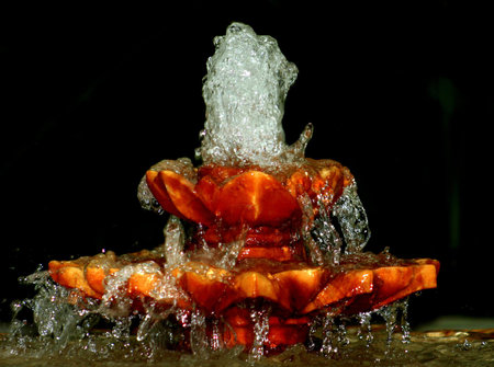 A fountain with water spraying from the top.の写真素材