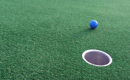 Adventure Golf, ball rolling towards hole.の写真素材