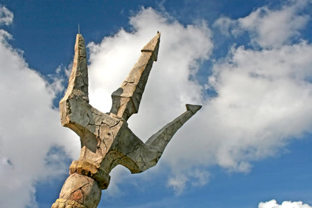 A stone trident with sky and cloudsの写真素材
