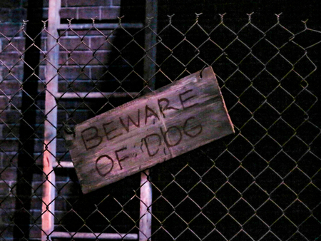 A Beware of the Dog sign on a wire fenceの写真素材