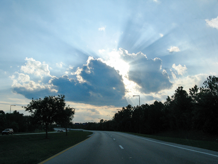 Rays of sunshine coming out of a cloudの写真素材