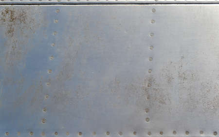 old rusty metal aluminum background with rivetsの写真素材