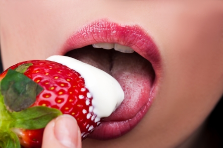 women sexy mouth with a strawberryの写真素材