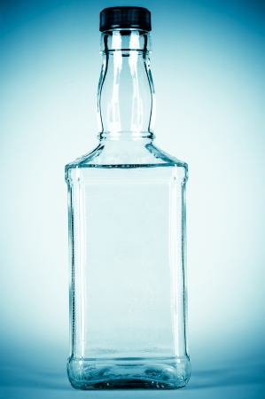 bottle for alcohol isolated on a blue backgroundの写真素材