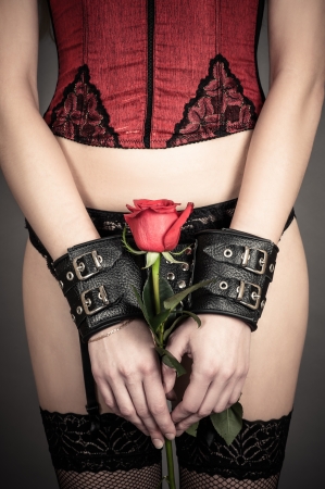 beautiful woman holding a red roseの写真素材
