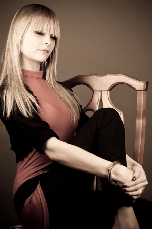 beautiful woman sitting on a chairの写真素材