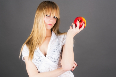 modern girl holding a appleの写真素材