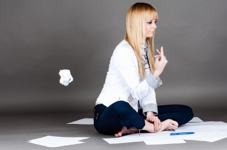 beautiful student throws a spoiled paperの写真素材