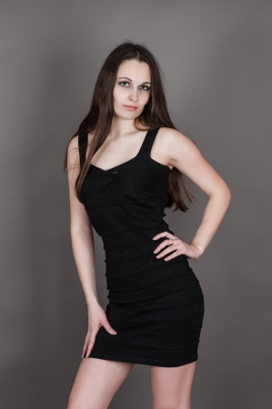 beautiful brunette in a black dressの写真素材