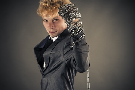 young businessman raises his arm up with a chainの写真素材