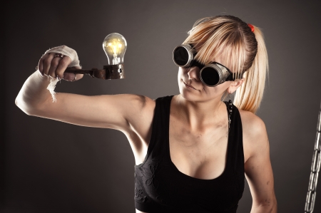 crazy creative woman looking at a light bulbの写真素材