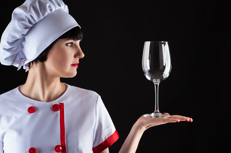 chef looking for a glass isolated on a black の写真素材