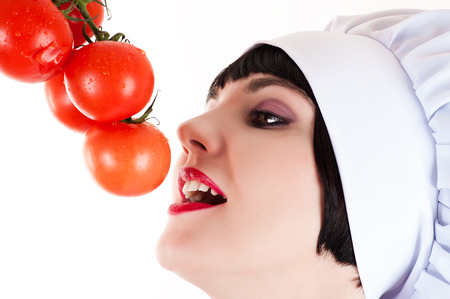 chef reaches for ripe tomatoesの写真素材