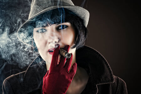 beautiful glamorous woman in retro style with cigarの写真素材