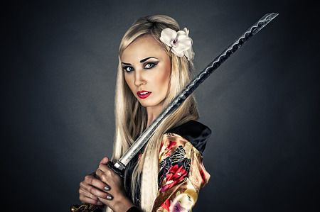 portrait of a woman with samurai swordの写真素材