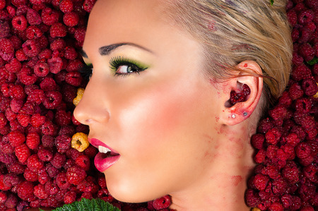beautiful woman face in profile raspberry closeupの写真素材