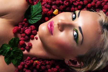fashion beautiful face in raspberriesの写真素材