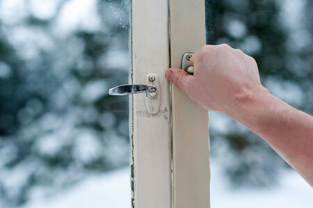 man opens old windowsの写真素材