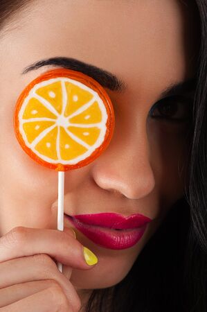 beautiful woman and a bright lollipopの写真素材