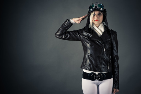 woman with aviator helmet salutingの写真素材