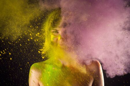 attractive girl in Holi colors on a black backgroundの写真素材
