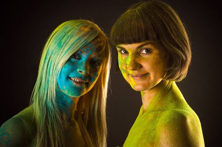 two beautiful woman in colors Holiの写真素材