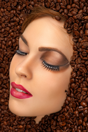beauty face with bright makeup in coffee beansの写真素材
