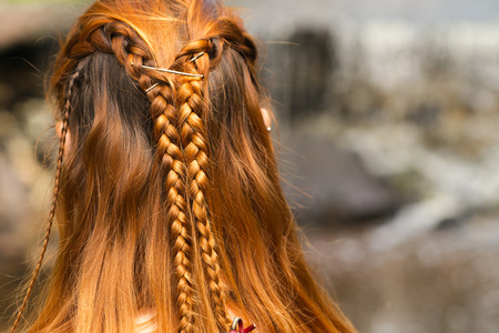 beautiful braid hairstyle on redhead womanの写真素材