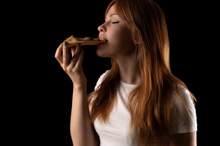attractive young girl eating pizzaの写真素材