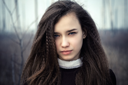 Portrait of a beautiful teenage girl closeup outdoorsの写真素材