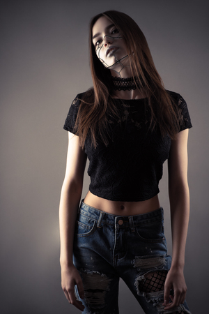 Young fashion cyberpunk girl cut out on gray backgroundの写真素材