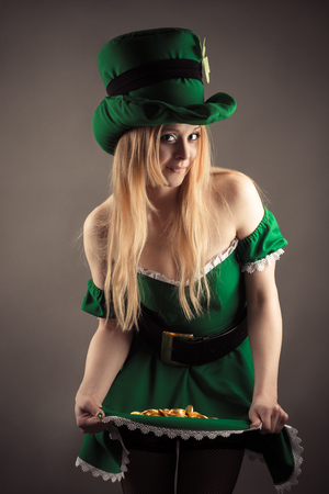 attractive woman in image leprechaun with coins in skirtの写真素材