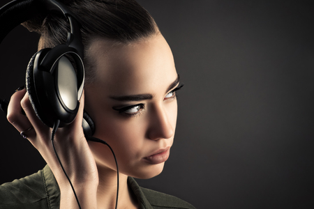 attractive girl listening music through headphonesの写真素材