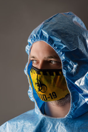 portrait man in chemical protection suit and mask closeup
