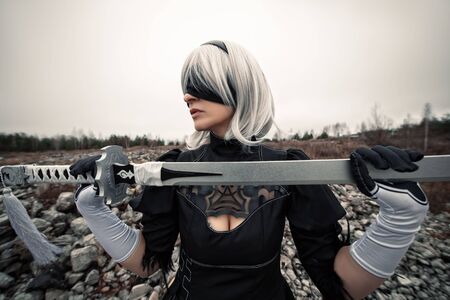 woman in white wig and sword with blindfoldの写真素材