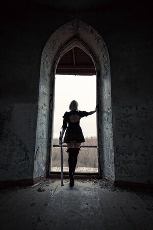 adult woman in the dark room with sword, cosplayの写真素材