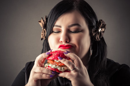 fat woman happy looking at hamburger closeup