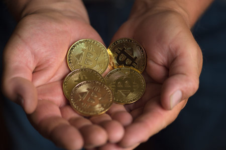 bitcoins in man hands