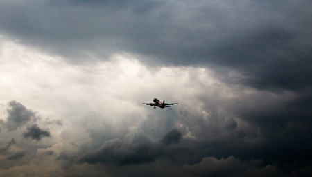 Aircraft flying in stormyの写真素材
