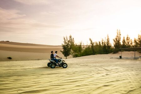 Racing quad jumping sand dunesの写真素材