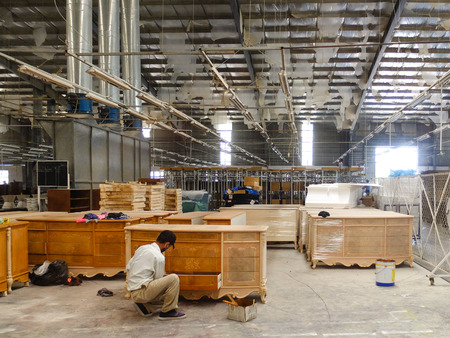 Vietnam Binh Duong city February 24 2015: Workers are a factory export furniture Completing the final stage to pack the product th vd plants grow very much in the Binh Duongのeditorial素材
