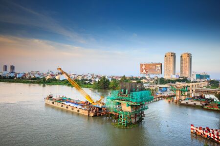 Hochiminh City Vietnam June 3 2014: the construction Workers steel and beton pier for metro lines crossing the Saigon Riverのeditorial素材