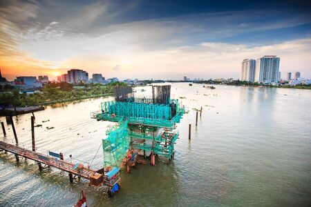 Hochiminh City Vietnam June 3 2014: the construction Workers steel and beton pier for metro lines crossing the Saigon Riverのeditorial素材